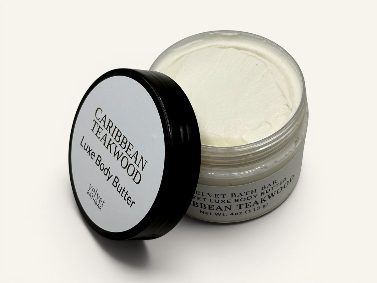 Velvet Bath Bar Caribbean Teakwood Luxe Body Butter in a clear jar with a black lid. White cream texture.