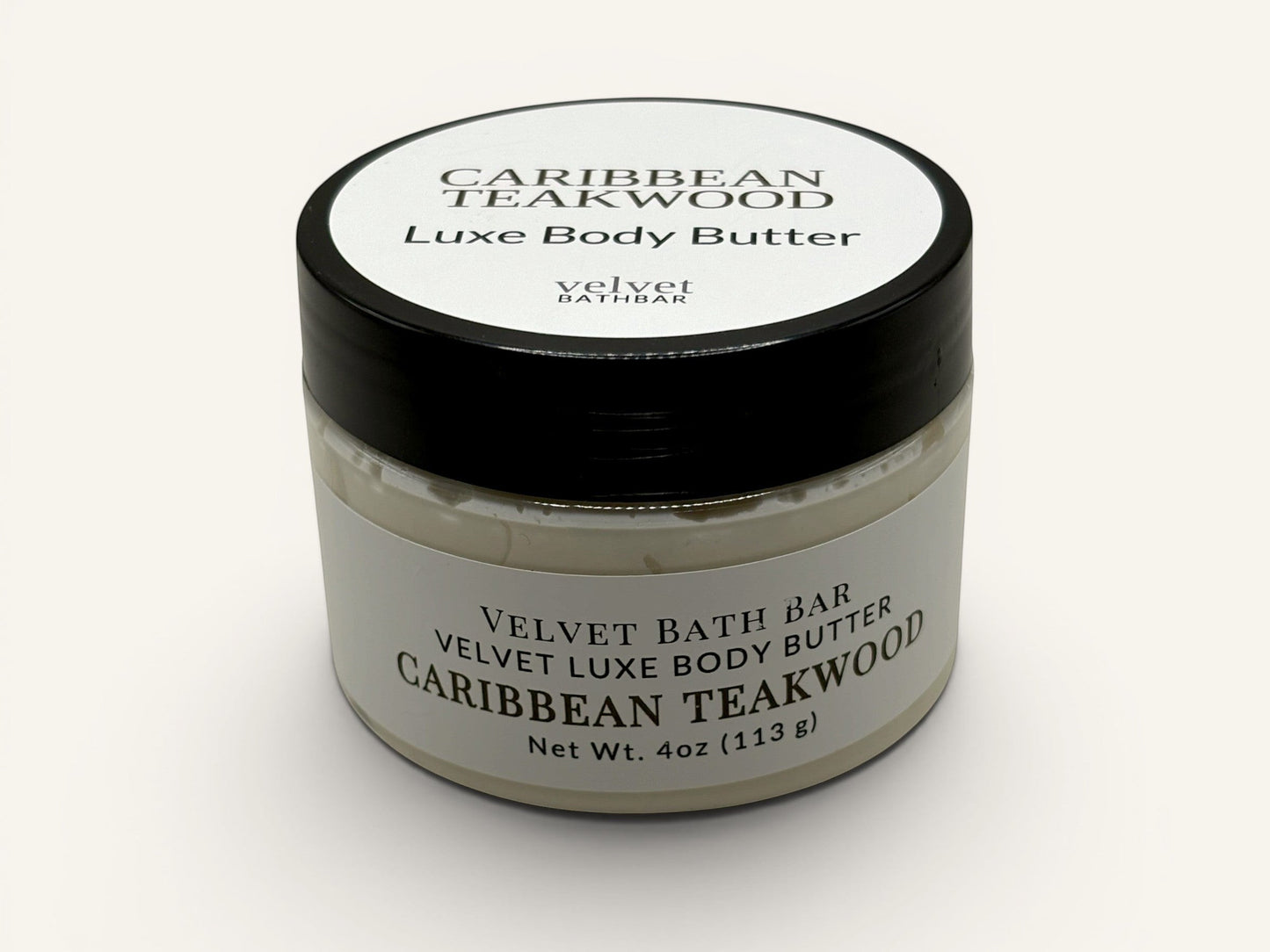 Velvet Bath Bar Caribbean Teakwood Luxe Body Butter in a clear jar with a black lid. Net Wt. 4oz.