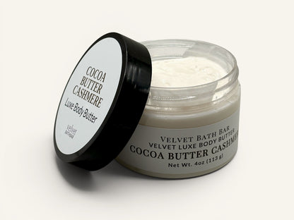 Velvet Bath Bar Cocoa Butter Cashmere Luxe Body Butter in a clear jar with a black lid. Creamy texture.