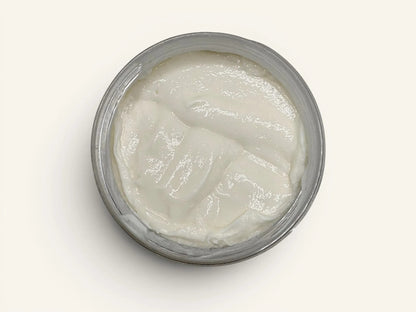 Velvet Luxe Body Butter in Sunflower Nectar, a creamy white body butter with a rich texture in a silver jar.